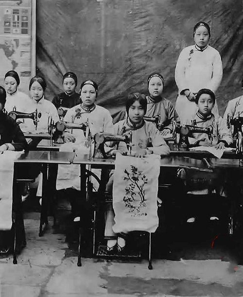 women learning to use sewing machines